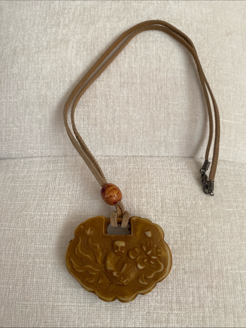 Fun Buddha pendant on suede cord . 20” inches